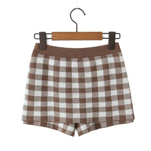 Close-up of knit checkerboard shorts with fine texture and elastic high-waisted band