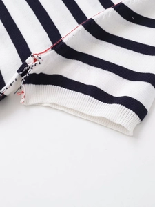 Detailed macro shot of striped knit fabric with contrasting red stitching accents