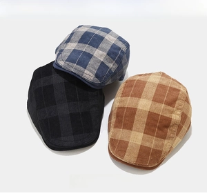 Detailed texture of corduroy plaid beret hats in blue, dark grey, and brown colors