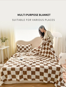 Checkerboard plush blanket in brown and beige showcased in a cozy bedroom setting