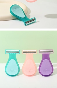 Detail shot of multi-colored portable shavers for women in teal, pink, and purple colors