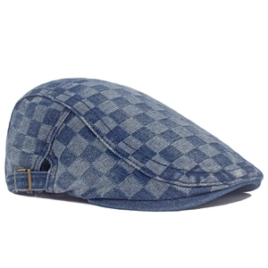 Detail of blue checkerboard denim beret showing vintage fabric and brass side buckle
