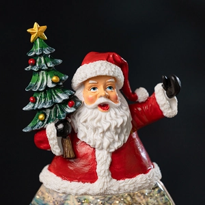 Festive Santa Claus music box with mini Christmas tree and snow globe crystal ball