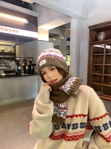 Detailed view of Fair Isle knit beanie with heart and snowflake patterns on thick fabric