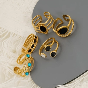 Five-piece gold stainless steel open ring set with enamel inlays and beaded details