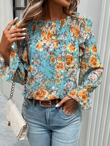 Detail of smocked round neck and ruffle cuffs on women's floral sky blue blouse
