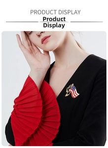 Detail of USA flag brooch with red white blue enamel and gold tassels on a black top