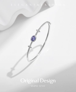 Close-up of S925 sterling silver cuff bracelet with purple gemstone and pavé diamonds