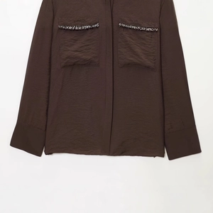 Deep chocolate satin long sleeve shirt with sequined pocket trim on white background
