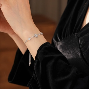 Close-up of rhodium plated floral cluster bracelet with sparkling zircon stones on wrist