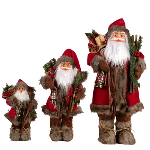 Standing Santa Claus figurines set with lanterns and gift bags on white background