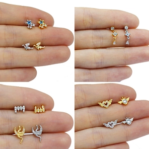 Collection of golden and silver ear studs featuring dragon, heart, and star designs