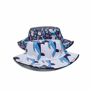 Detail of kids sun hats with blue ocean motifs and dolphin prints in quick-dry fabric