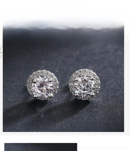 Detail of 925 sterling silver halo stud earrings with sparkling cubic zirconia stones