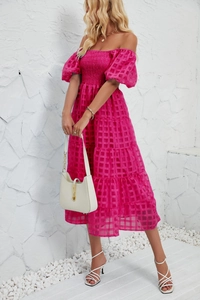 Detail of rose red off-shoulder dress featuring plaid textured fabric and elastic smocked bodice