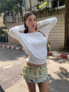 Slim fit white long sleeve top paired with vintage embroidered denim mini skirt