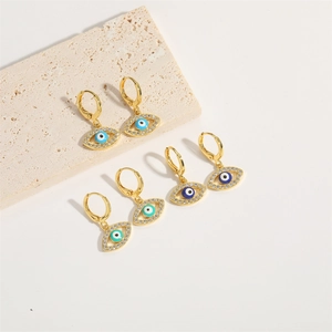 Three pairs of gold evil eye hoop earrings with light blue, dark blue, and turquoise stones