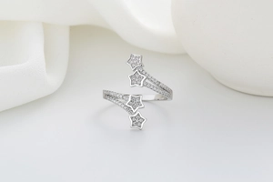 Detail showing asymmetric silver star rings with twisted bands and pavé zirconia stones
