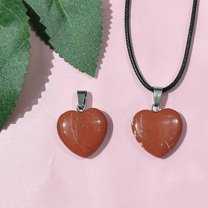 Macro shot of 20mm heart-shaped red jasper stone pendants with silver metal clasps
