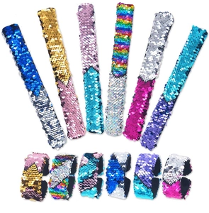 Detail of reversible sequin slap bracelets in six vibrant dual-color flip combinations