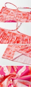 Detailed view of pink tropical floral print with adjustable straps and elastic pleats