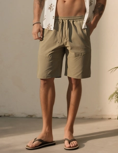 Detail of khaki drawstring waist on loose summer fitness shorts for men