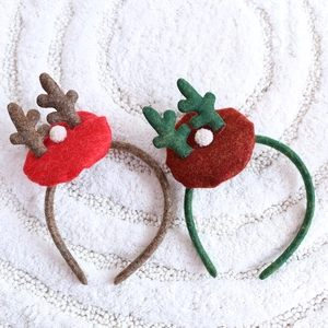 Christmas reindeer antler headbands in brown and green with soft white plush pom-poms