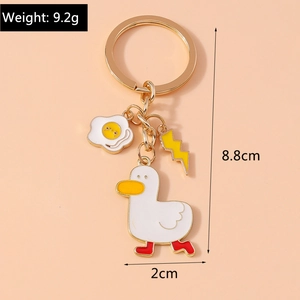 Detailed view of cartoon white duck keychain with egg charm and product dimensions