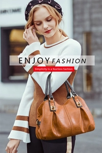 Brown leather tote bag with black handles and gold hardware shown in street style