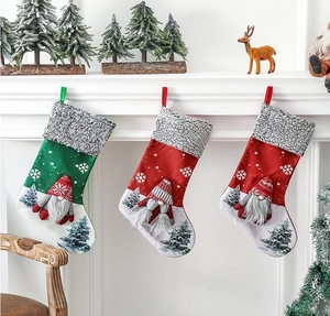 Three Christmas stockings with Santa 3D dolls hanging on a decorated fireplace mantle