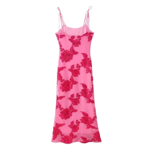Detail of pink mesh midi dress featuring intricate red floral embroidery and tie straps
