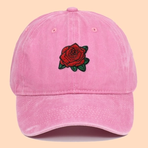 Pink washed cotton baseball cap featuring detailed red rose embroidery on the front