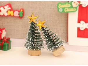 Miniature Christmas trees with snow effect, gold stars, and wooden bases for DIY decor