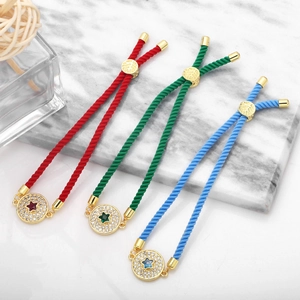 Detail of adjustable couple rope bracelets with zircon star charms in red, green, and blue