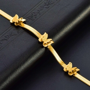 Elegant gold butterfly chain bracelet with polished textured charms on snake chain