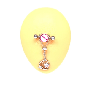 Detail of silver nipple ring with sun and moon pendants on a display model