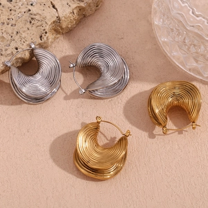 Detail of twisted spiral texture on stainless steel hoop earrings in gold and silver