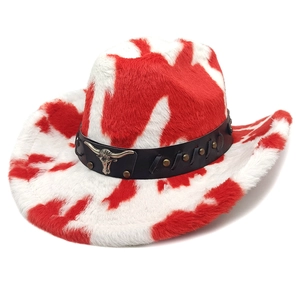 Detail of red and white cow print cowboy hat with faux fur texture and metal bull head