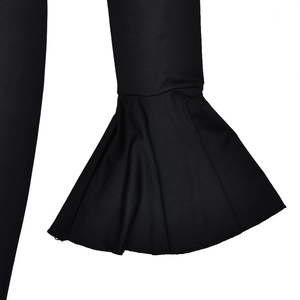 Detailed close-up of the black dress featuring flared bell sleeves and ruffle design