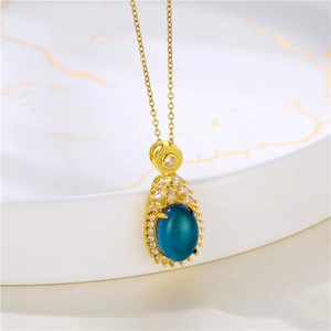 Detailed shot of color-changing drop necklace with blue stone on marble ceramic tray