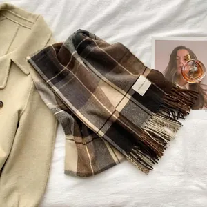 Classic plaid cashmere scarf in brown and grey with tassels on white background