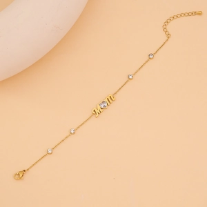 Detail of gold Mom heart bracelet with sparkling cubic zirconia and lobster clasp