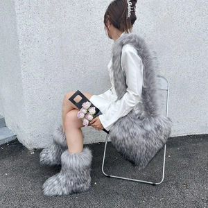 Detail shot of heart-shaped faux raccoon fur crossbody bag in chic silver grey