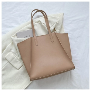 Detailed top view of a minimalist beige tote bag with long straps for office commute