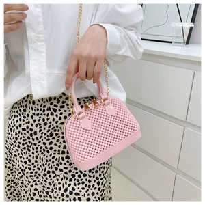 Detailed macro shot of pink PVC jelly bag featuring 3D texture and a gold chain strap
