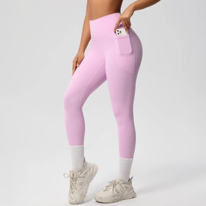 Detail of high-waisted yoga leggings with functional side pocket for mobile phone storage
