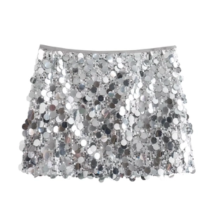 Close-up of sparkling silver sequins and flexible waistband on a mini skirt