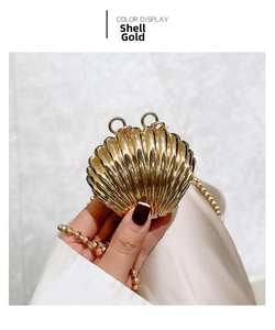 Detail of a shell-shaped gold metal evening bag featuring a beaded chain strap and textures