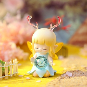 Close-up of resin deer fairy figurine with blue dress and wings for desk decoration