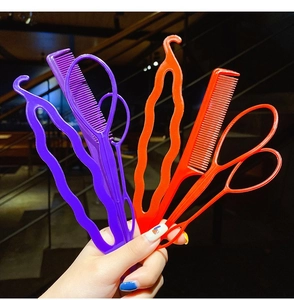 Close-up of colorful plastic hair styling tools including combs and topsy tail loop tools